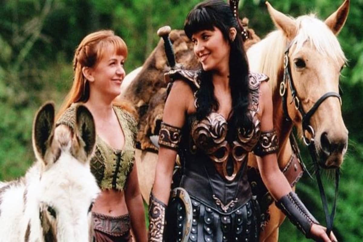 Xena and Gabrielle walking together with their horses laughing and smiling.