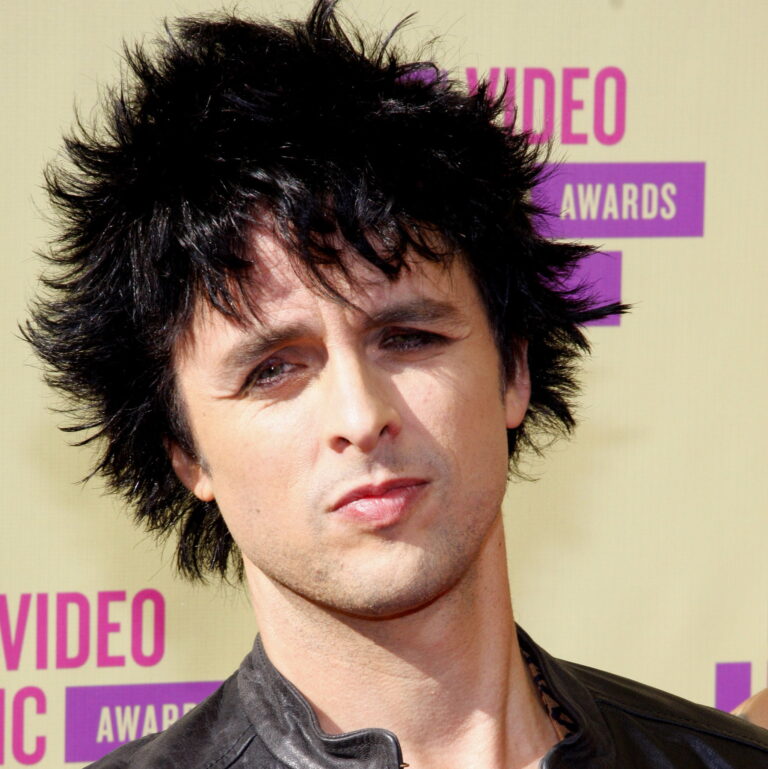 Billie Joe at a carpet event, smirking.