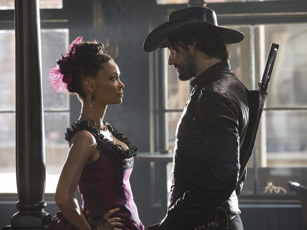 Thandiwe Newton in her roll for Westworld standing in front of a cowboy.