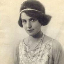 Black and white image of Michel Strange with clothes from that time period. Posing for a picture.