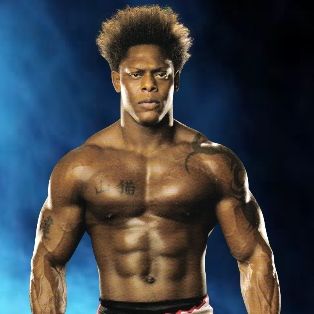 Portrait of Orlando Jordan in his boxing outfit exposing muscles with a serious expression.