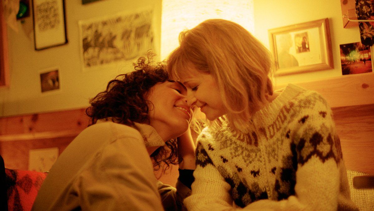 Leila and Sadie sharing an intimate moment smiling while about to share a kiss.