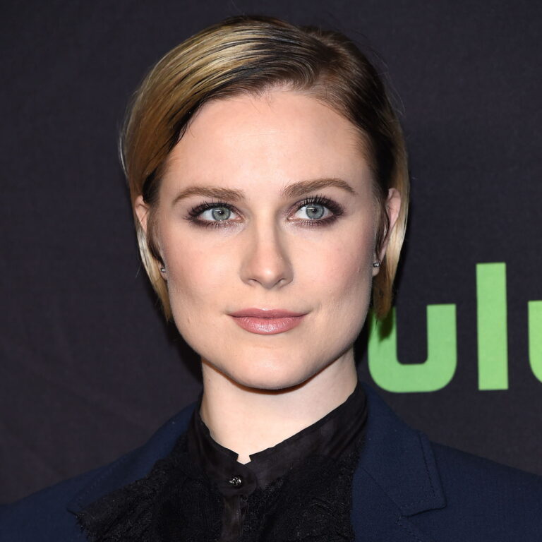 Evan Rachel Wood with short hair and a blue blazer, looking to the side durin a Hulu premiere.
