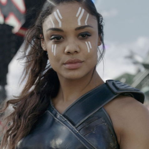 Tessa Thompson as Valkyrie, standing confidently in a battlefield.