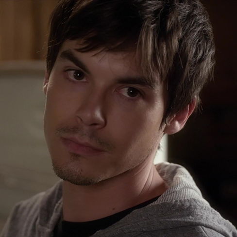 Tyler with unbrushed hair tilting his head and looking ahead.