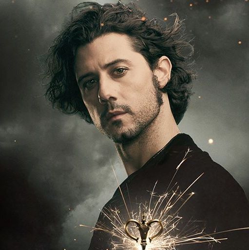 Eliot looking to his side with a stern expression.