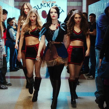 Tracy Maddy and Leena strutting down the hall with their cheerleader uniform.