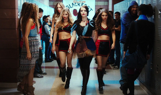 Tracy Maddy and Leena strutting down the hall with their cheerleader uniform.