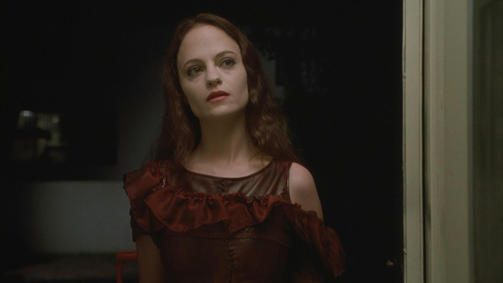 May standing confidently next to a door looking at someone off camera.