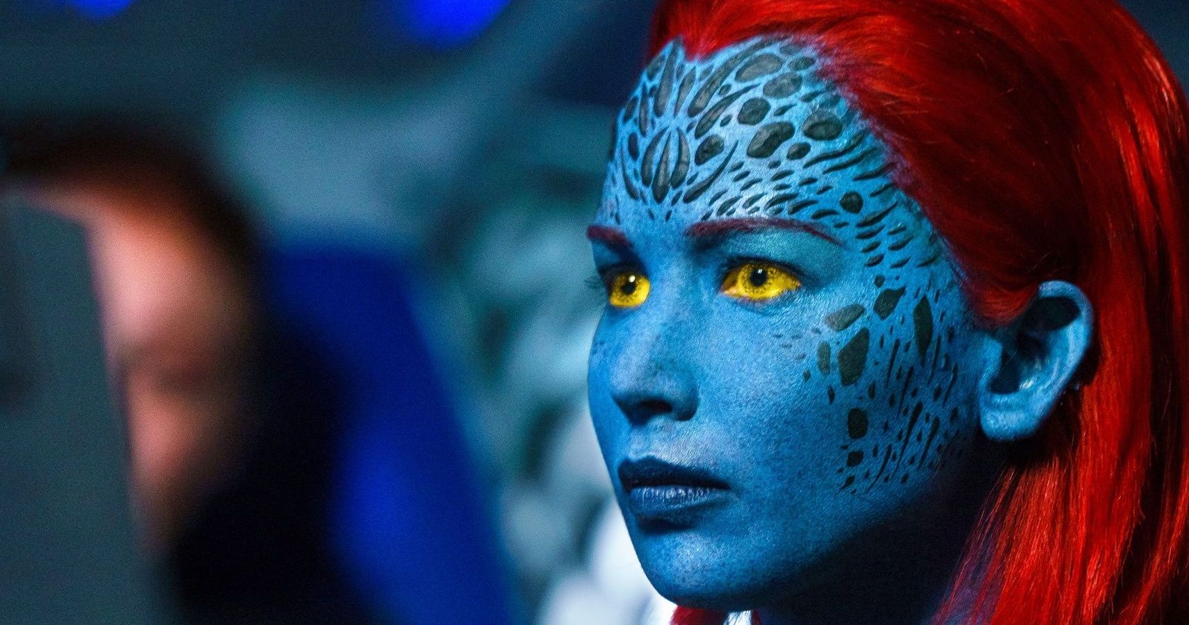 Jennifer Lawrence as Mystique, looking at someone off camera in her natural form.