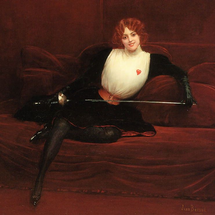 Julie D’Aubigny lying on a couch smiling with her fencing outfit and sword, looking in front of her.
