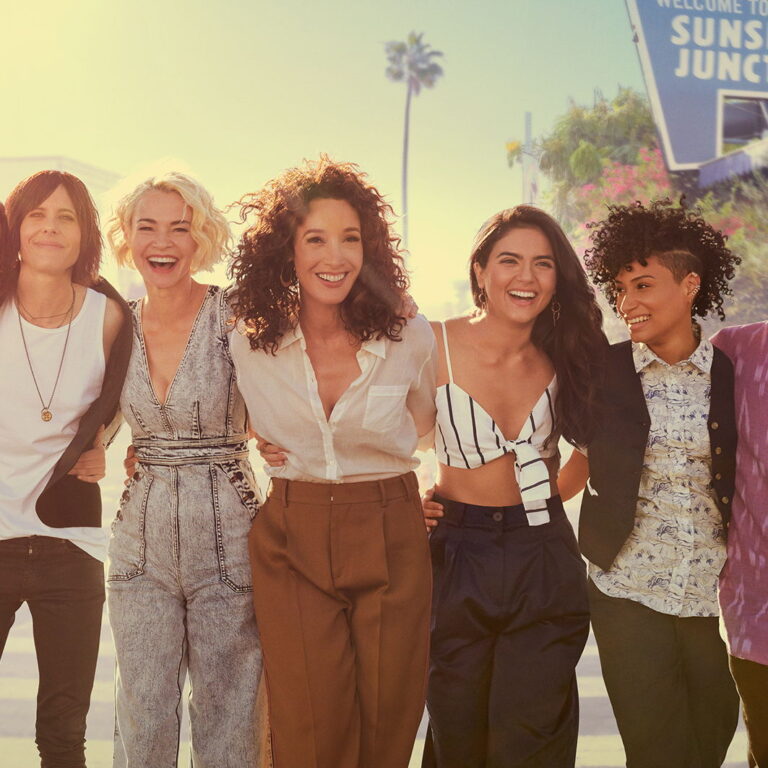 The cast of The L Word, wearing summer outfits and holding on to eachothers' waist.