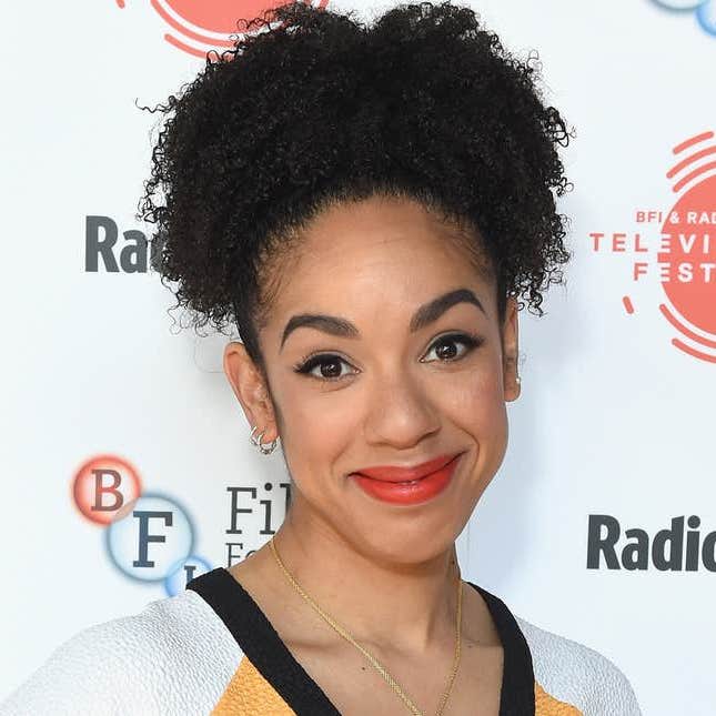 Pearl Mackie smiling at the camera during a tv event with her hair up.