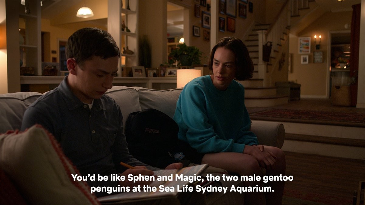 Image of Casey talking to her brother Sam seriously while he looks shyly to the ground. They are sitting on a couch together.