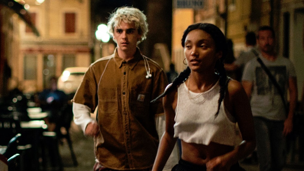 Caitling and Fraser run in the street during the night with concerned expressions.