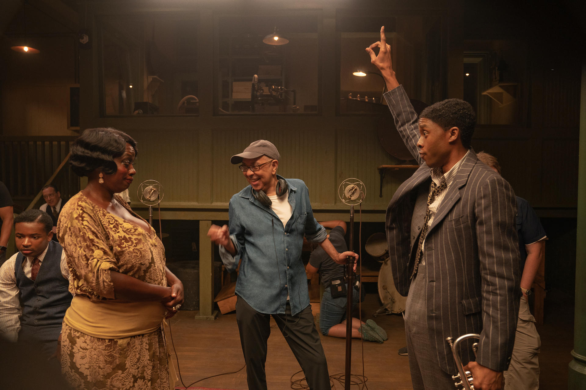 Ma Rainey and Levee facing eachother, and a director between them encouraging them both.