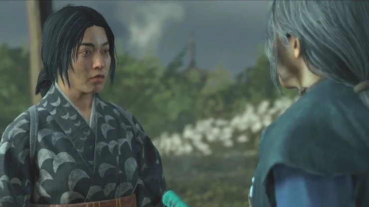 Photo of Mai and Lady Masako during a mission cutscene. Mai is looking intently at Lady Masako in the outdoors with white flowers in the back.