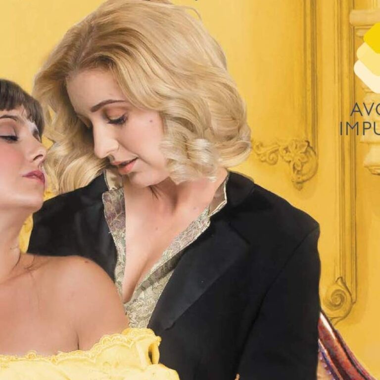 Image of the book cover that has two women, one wearing a long golden dress and the other woman has a blazer type suit, both are looking at each other with their eyes closed.