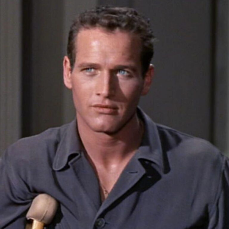 Brick supported by crutches, looking off into the distance with a serious look on his face.