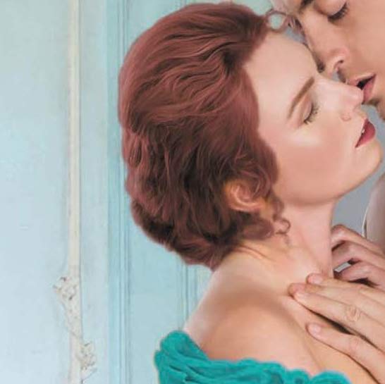 Amelia wearing a low cut dress closes her eyes about to kiss a man.