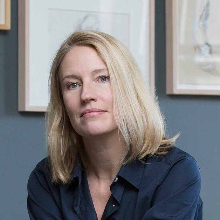 Portrait of Jennifer, she has a collared shirt and is calmly smiling.