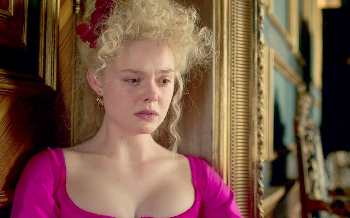 Elizabeth holding a document with a very surprised expression.