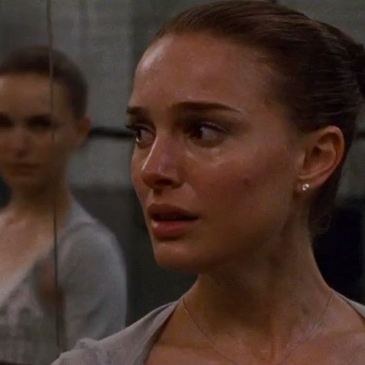 Nina looking over her shoulder scared while her reflection glares at her.