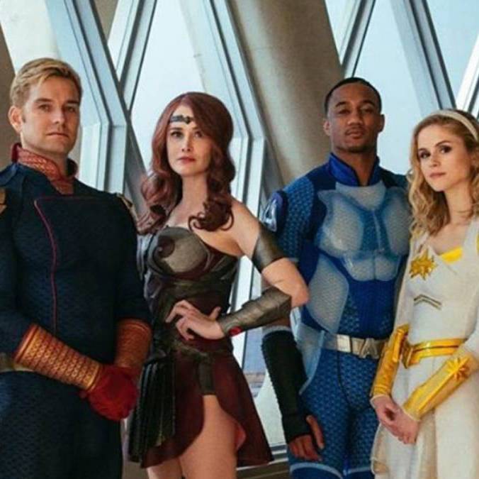The superheros all posing in their uniforms.