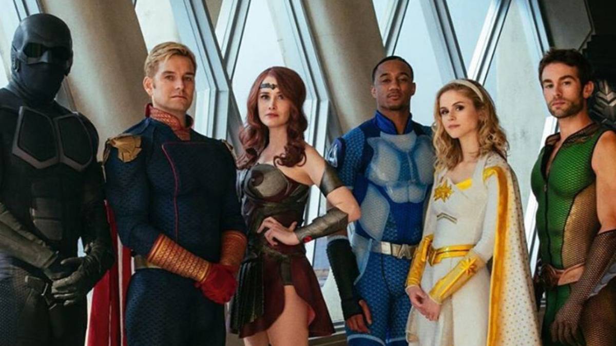 The superheros all posing in their uniforms.