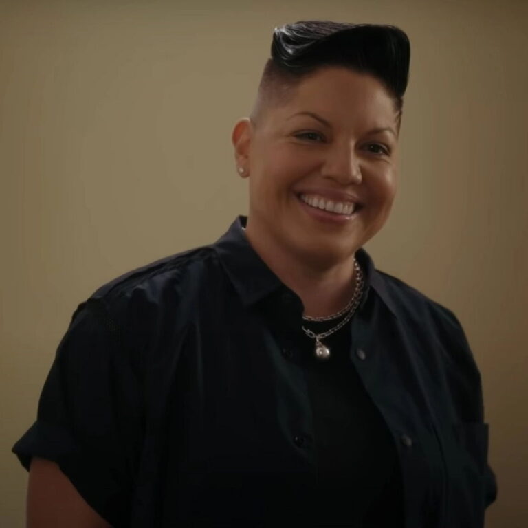 Che Diaz smiling looking at the viewer.