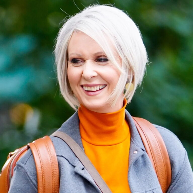 Miranda laughing while outdoors looking at someone out of frame.