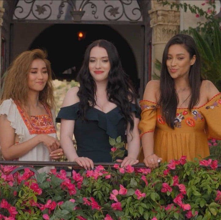 Madison, Jules and Stella standing together at a balcony looking below and smirking.
