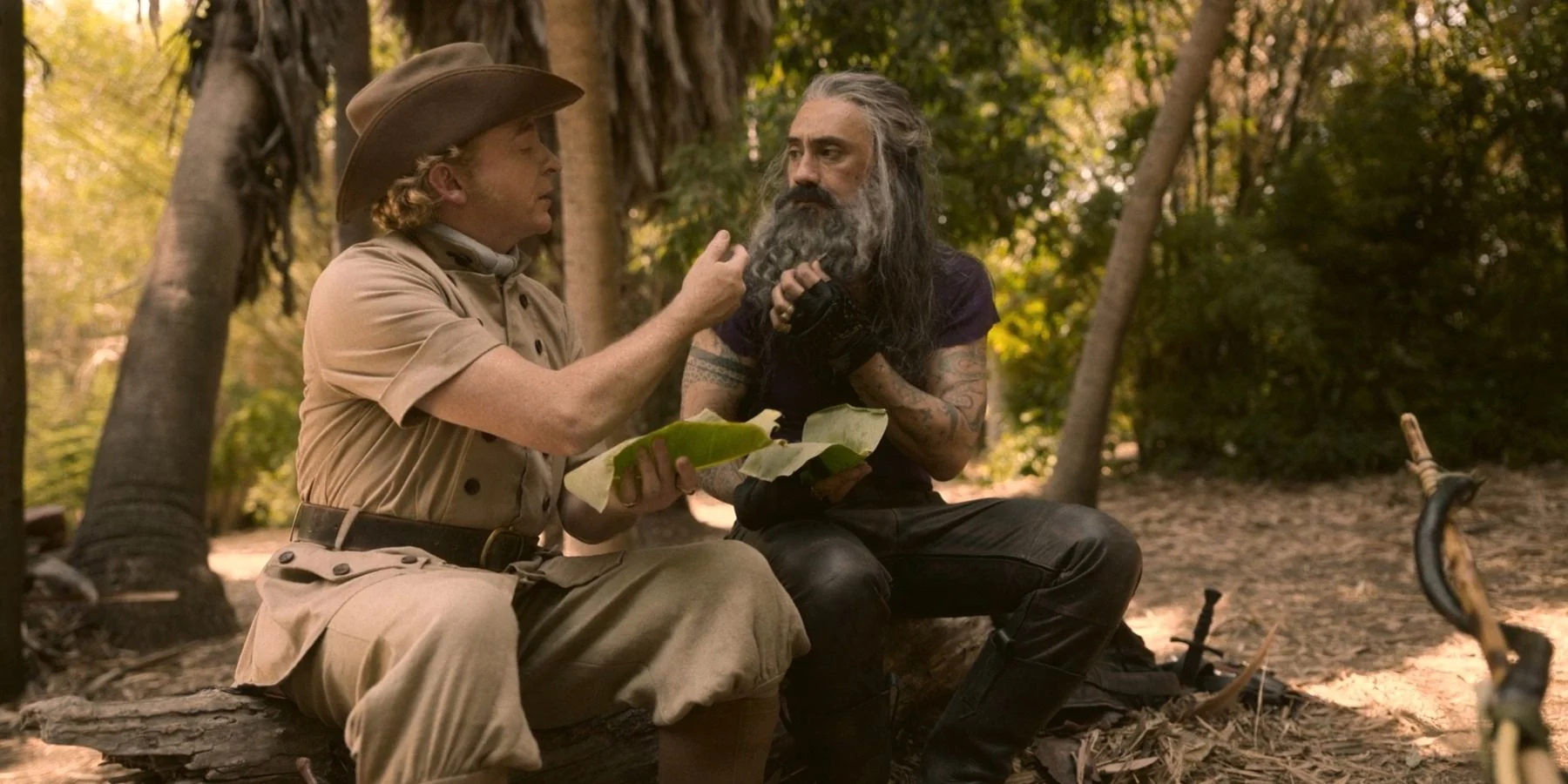 Ed and Stede sharing a close moment. They are sitting down together and are sharing a meal.