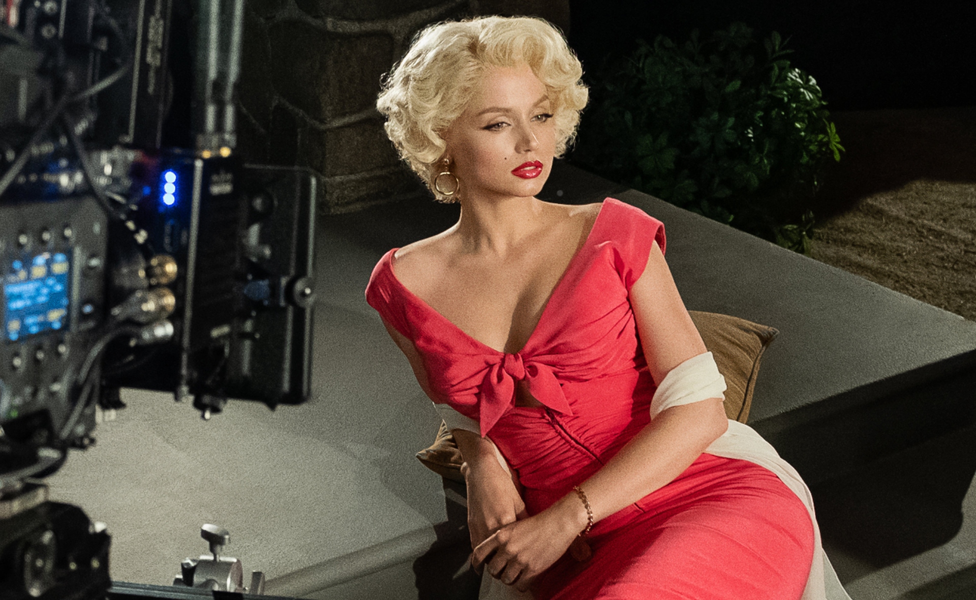 Marilyn sitting on a chair posing while on set.