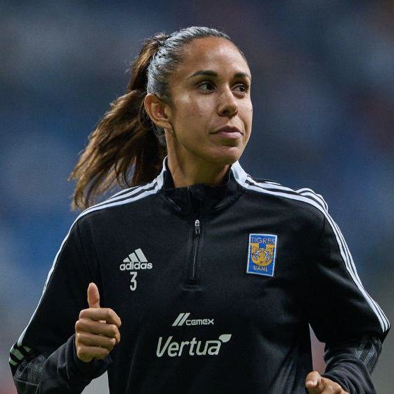 Bianca running int he field smiling looking at the crowd at a game.