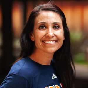 Victoria smiling for a softball team portrait.