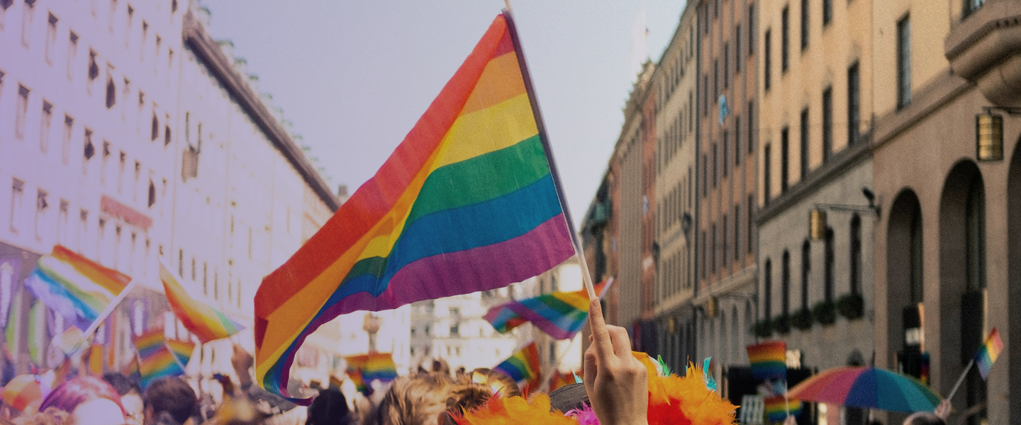 A pride parade showing the LGBTQ pride flag prominently