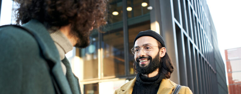 Two gay people meet on the street on their first date after meeting on a dating app.